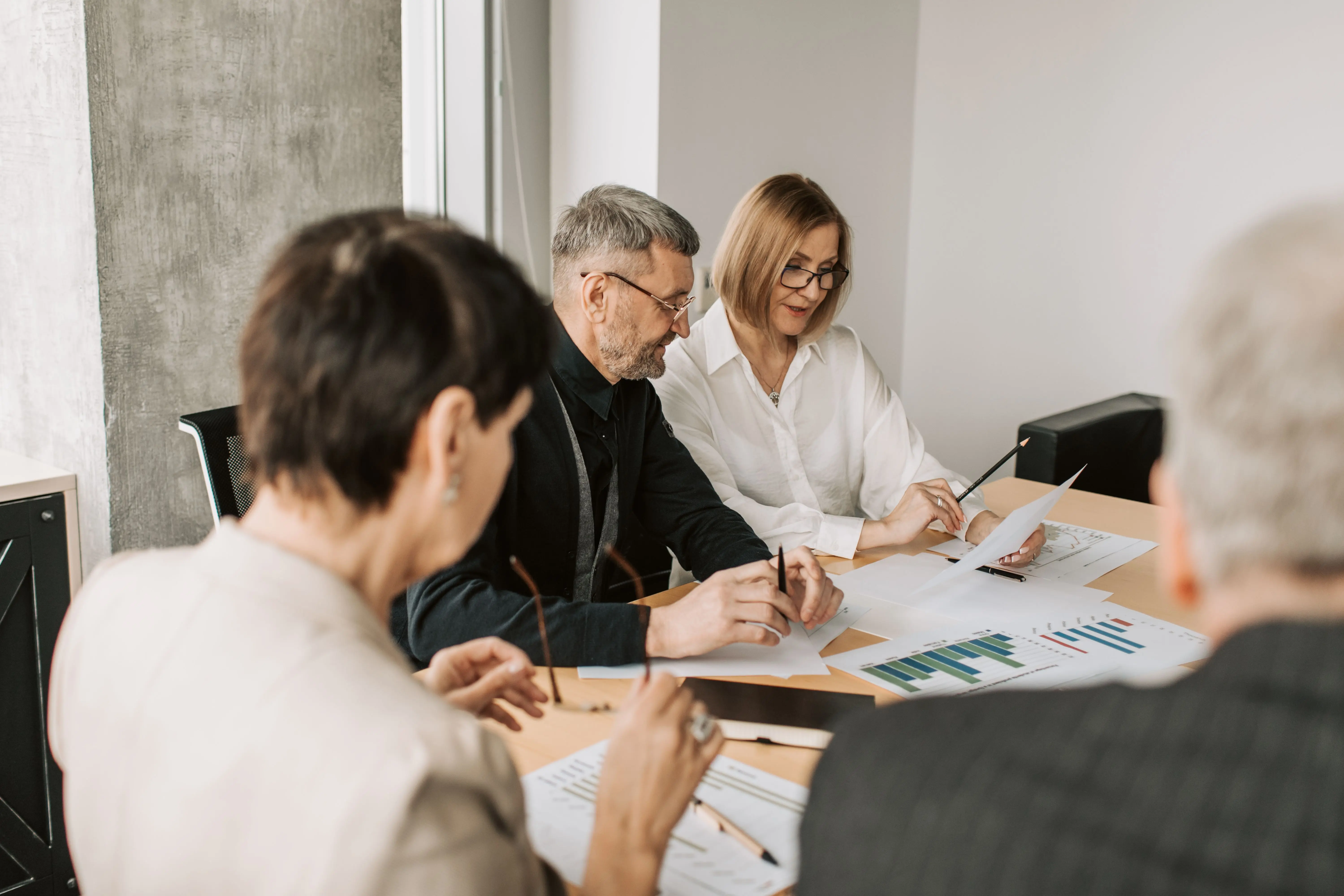 Professional investment team reviewing portfolio risk analysis